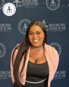 Gabrielle Eshiet in front of blue WSCL logo backdrop.